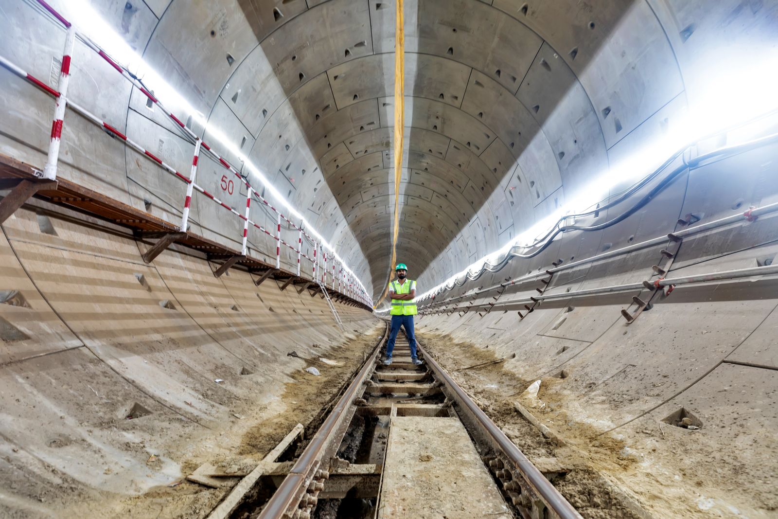 Engineer inspecting an underground metro construction tunnel