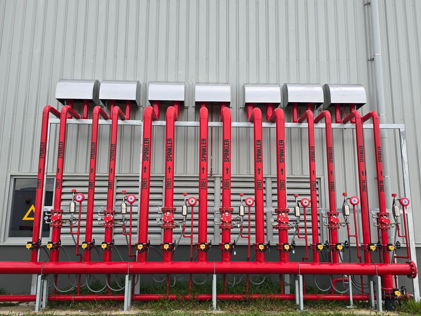 Industrial fire sprinkler system pipes installed along a ceiling