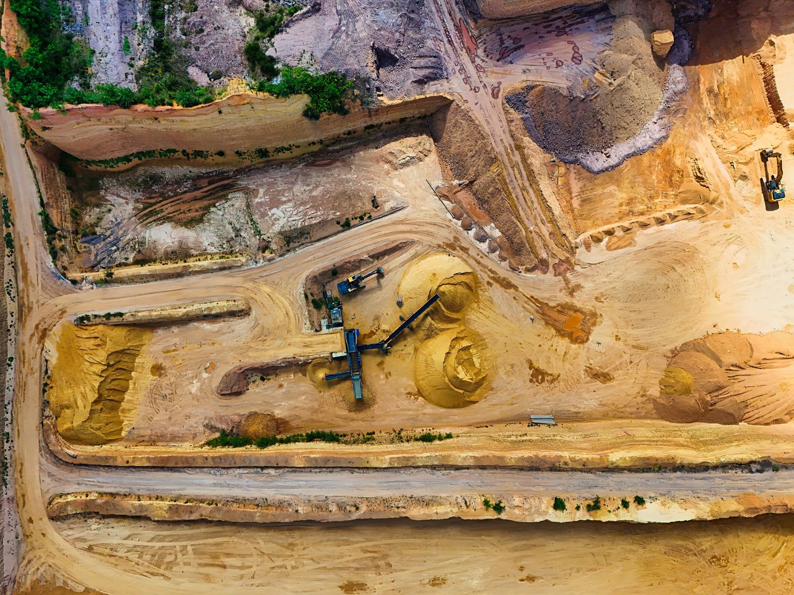 Aerial view of a quarry site with heavy excavation machinery